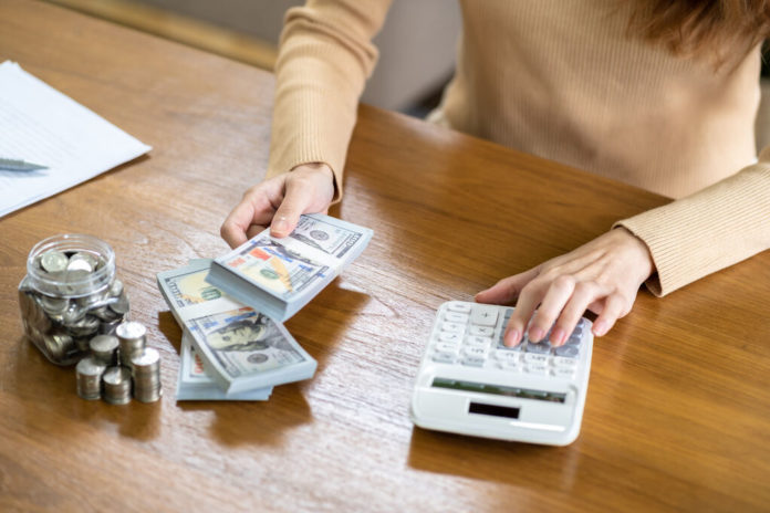 Saving money. Businesswoman Accountant verify growing business a